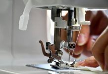 Serger vs Sewing Machine: Need Both? Person sewing fabric on a sewing machine