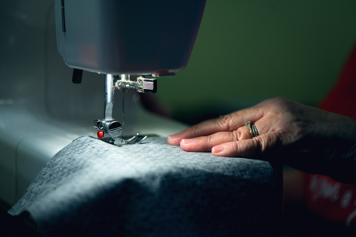 Person sewing at a machine