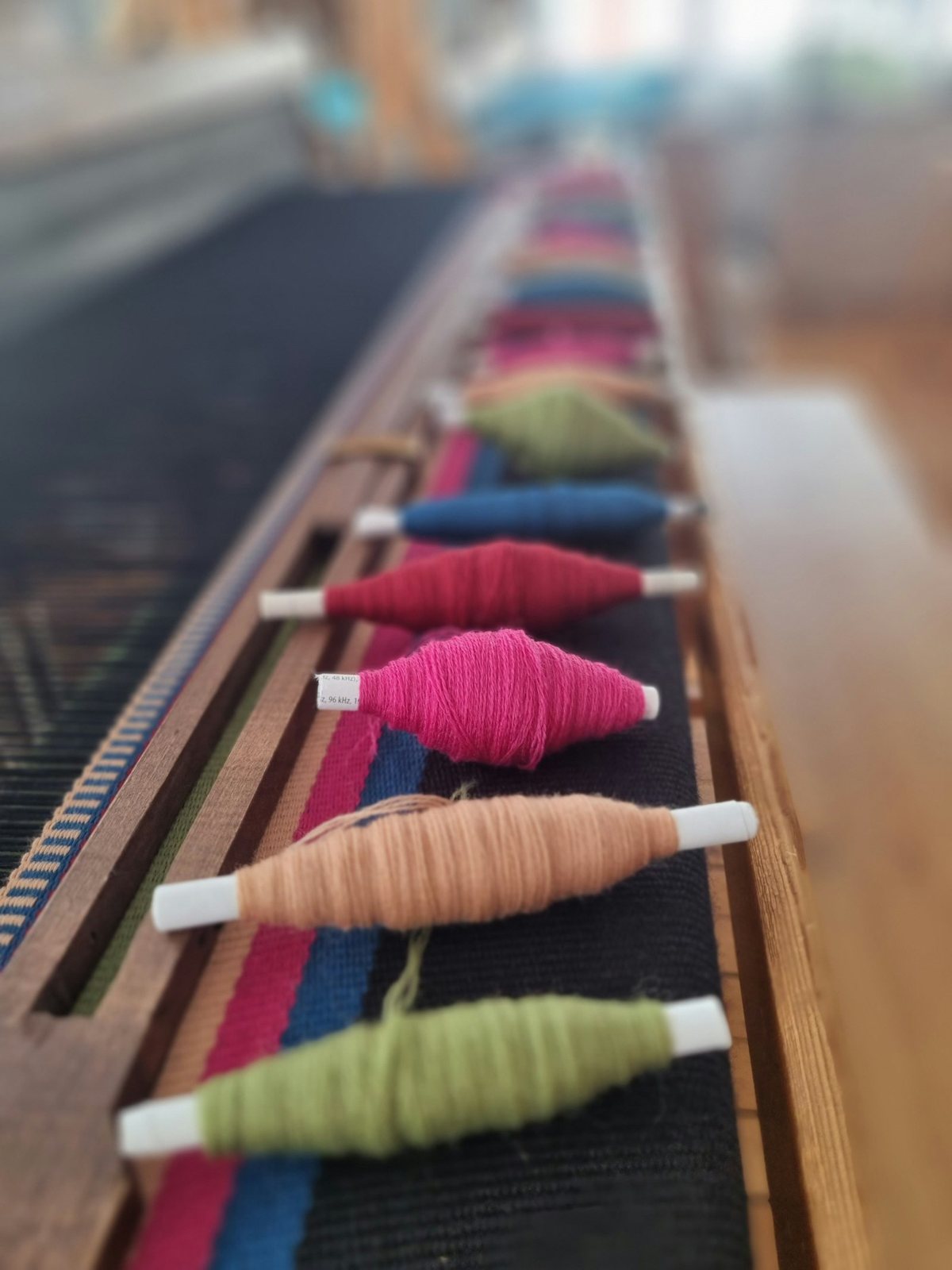 Row of thread spools on a table